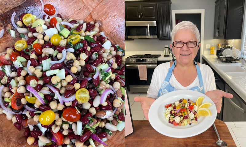 A close-up of a colorful bean salad with tomatoes and onions is on the left. On the right, an older woman in a kitchen smiles and holds a plate of the salad garnished with lemon wedges.