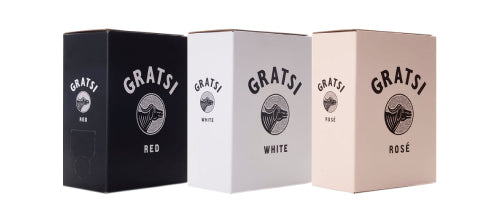 Three wine boxes labeled Gratsi are shown side by side. The boxes are black (Red), white (White), and light pink (Rosé), each with a circular logo and simple text indicating the wine type.