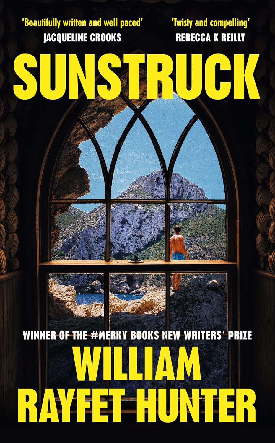 Book cover for Sunstruck by William Rayfet Hunter. Through an arched window, a person in orange stands on rocks by the sea, with cliffs and blue sky in the background. Bold yellow title and author text overlay the image.
