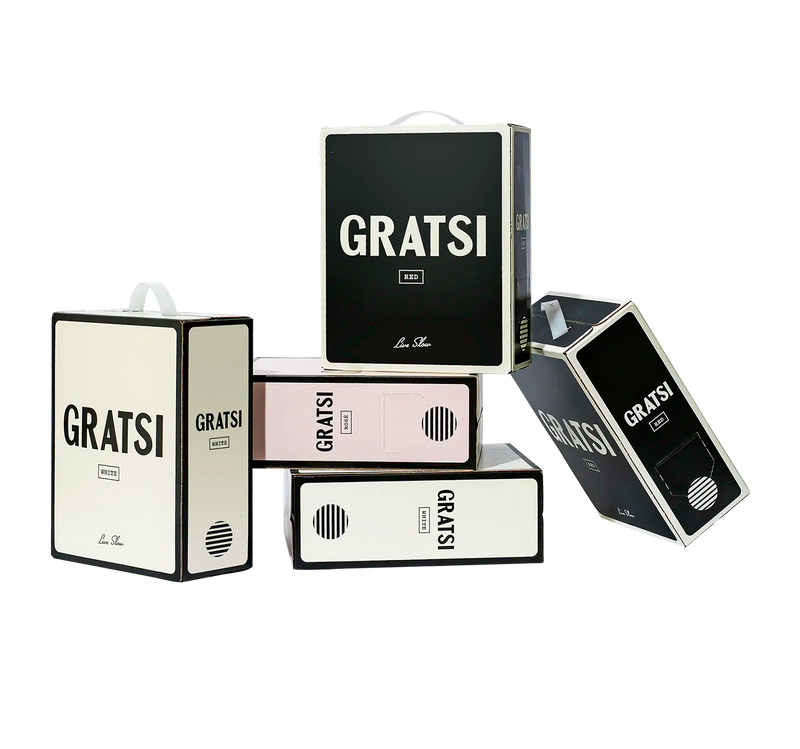 Five boxed wine containers labeled GRATSI, in black, white, and pink colors, are stacked in a minimalist arrangement against a plain white background.