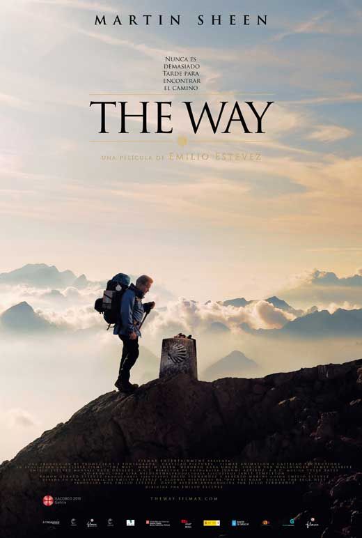 A hiker with a large backpack stands on a mountain peak at sunrise, looking down at a stone marker. The sky is clear, with mountains in the background. The poster is for the film The Way, starring Martin Sheen.
