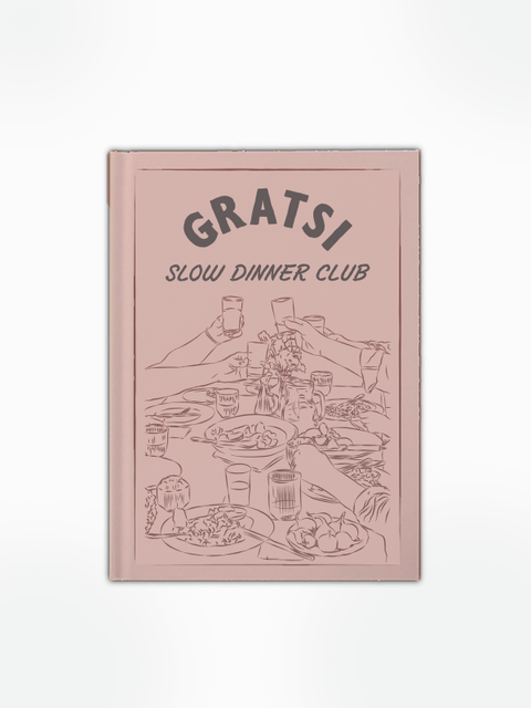 The Gratsi Slow Dinner Club Book features a pink cover with a line drawing of people raising glasses and sharing a meal, celebrating favorite recipes and drinks.
